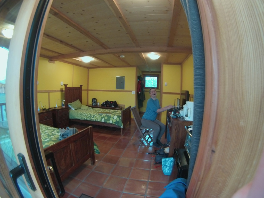 Fisheye view of lady sitting on chair in small cabin
