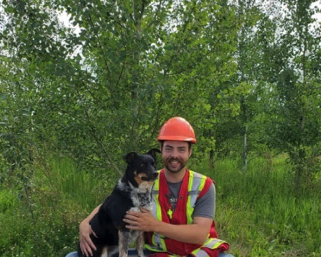 man in forest with dog