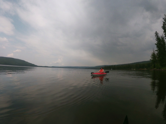 wide view of lake with one person kayaking