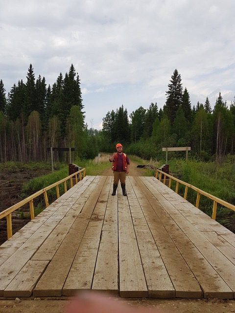 man standing on bridge