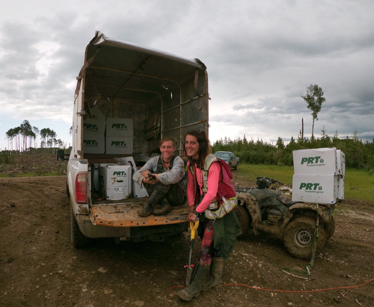 2 girls posing with tree planting truck